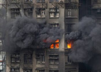 At least 75 dead as Hong Kong firefighters battle burning towers for second day